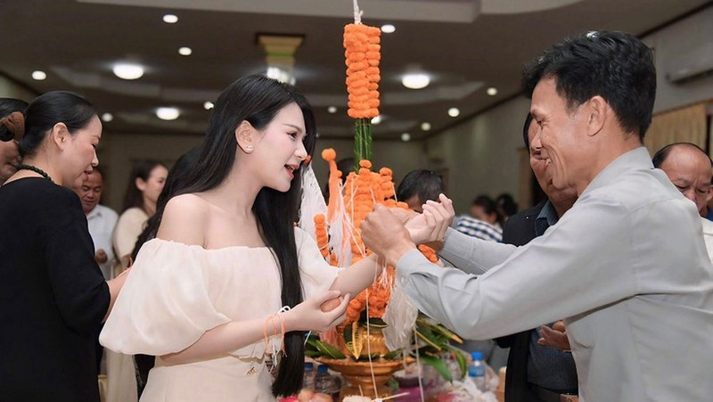 An Thu An at a traditional Lao wrist-tying ceremony. (Photo: Courtesy of the artist)