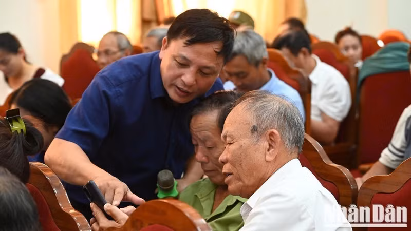 Staff of the Ha Tinh Centre for Science, Technology and Digital Transformation guide residents in installing and using the i-HaTinh application. (Photo: NGO TUAN)