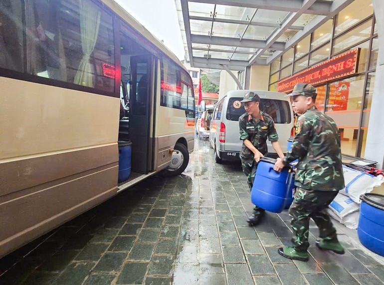 Military medical staff load Chloramin B – a water disinfectant chemical – onto a truck.