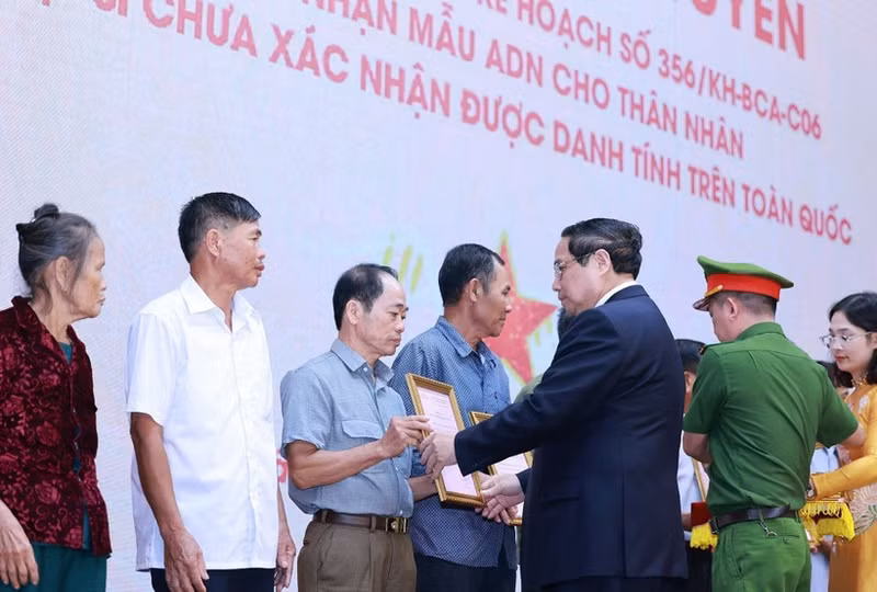 PM Pham Minh Chinh presents the announcements of martyrs' DNA testing results to representatives of families at the conference on July 25. (Photo: VNA)