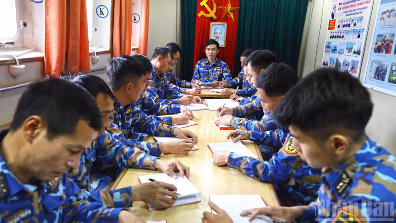 Major Ngo Quoc Hoi, political officer of Ship 267, chairs a Party meeting while the vessel is on mission at sea.