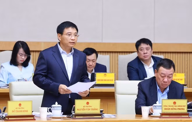 Minister of Finance Nguyen Van Thang reports on the socio-economic situation in November and the first 11 months of 2025 at the meeting. (Photo: VNA)