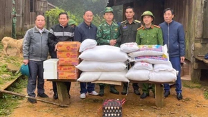 Providing food and supplies to Lao border protection forces isolated for days by floodwaters.