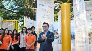 Editor-in-Chief of Nhan Dan Newspaper Le Quoc Minh speaks at the exhibition