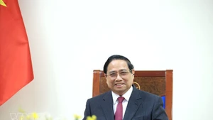 PM Pham Minh Chinh in the phone talks with his Singaporean counterpart Lawrence Wong. (Photo: VNA)