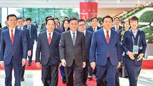 Permanent member of the Secretariat Tran Cam Tu and delegates attend the inauguration ceremony of the Press Centre and chair an international press conference on the 14th National Party Congress.