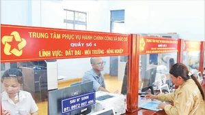 Local residents completing administrative procedures at the Public Administration Service Centre in Duc Co Commune, Gia Lai Province. (Photo: VNA)