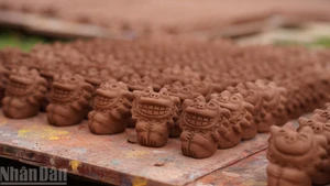 The signature eel-skin glaze, a lustrous brown to dark brown finish unique to Phu Lang, is crafted from wood ash and natural oxides, giving each ceramic piece a distinct character.