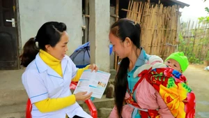 A healthcare worker offers reproductive health counselling, along with prenatal and newborn screening, to a local woman in Quang Ninh Province. (Photo: suckhoedoisong.vn)