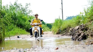 A postal worker in Tuyen Quang Province delivers parcels.