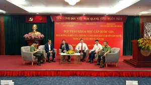 Delegates participate in a panel discussion at the symposium.