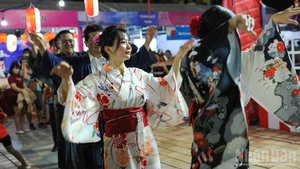 Participants join a traditional Japanese folk dance at the festival 