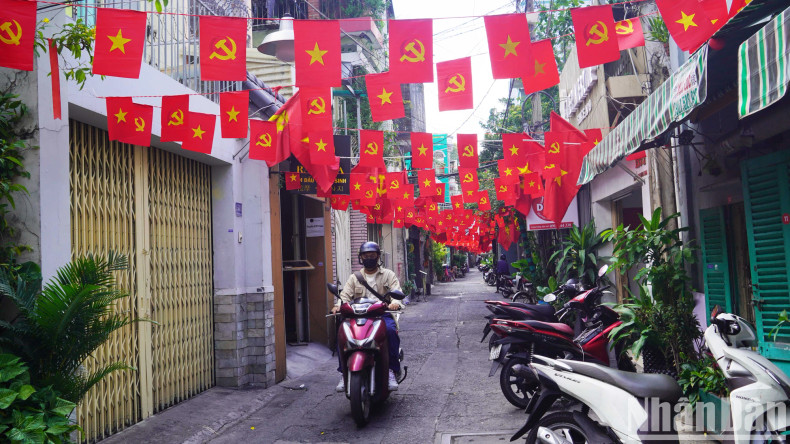 An alley in District 1 is sparkling with the colors of the red flag with yellow star. An alley in District 1 is sparkling with the colors of the red flag with yellow star.