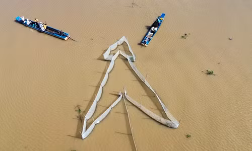 The rice fields are crowded with canoes, boats, and fishing nets during the flood season