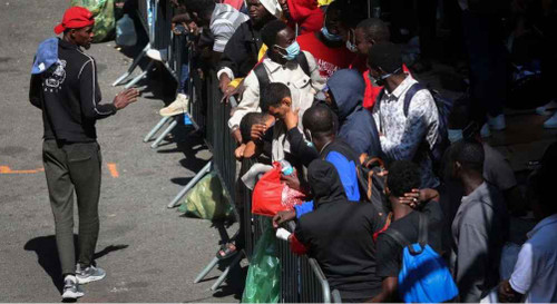 Recently arrived migrants to New York City wait on the sidewalk outside the Roosevelt Hotel in midtown, Manhattan, where a temporary reception center has been established in New York City, on August 1, 2023. (Photo: Reuters)