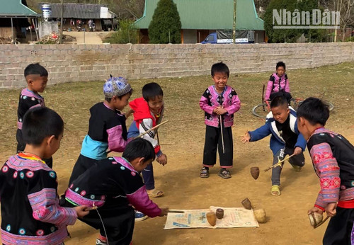 H’mong ethnic boys playing spinning tops H’mong ethnic boys playing spinning tops