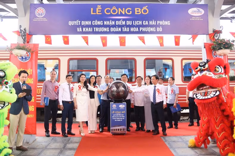 Delegates press the button to launch the first official journey of the train.