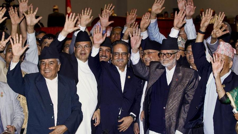 Nepalese Prime Minister Sushil Koirala (2nd R), Chairman of the Unified Communist Party of Nepal Pushpa Kamal Dahal "Prachanda" (C) raise hands after the adoption of the new constitution of Nepal (Photo: Xinhua)
