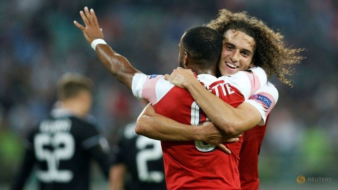 Arsenal's Matteo Guendouzi celebrates with Alexandre Lacazette after scoring their third goal. (Reuters)