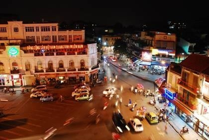 Pedestrians and motorists make their way through the Hanoi Old Quarter