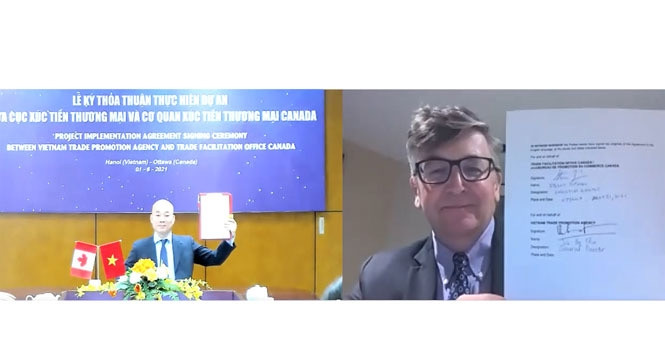  The cooperation agreement was signed by VIETRADE and TFO Canada via a virtual conference held on June 1. (Photo: hanoimoi.com.vn)