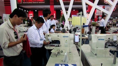 Visitors discovering a multi-needle sewing machine at the fair (Source: VGP)