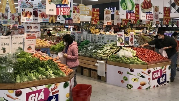Consumers shop at a supermarket in Hanoi. (Photo: VNA)