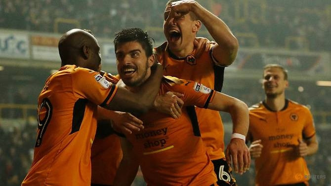 Wolves' Ruben Neves celebrates with Conor Coady and Benik Afobe after scoring their second goal. (Reuters) 