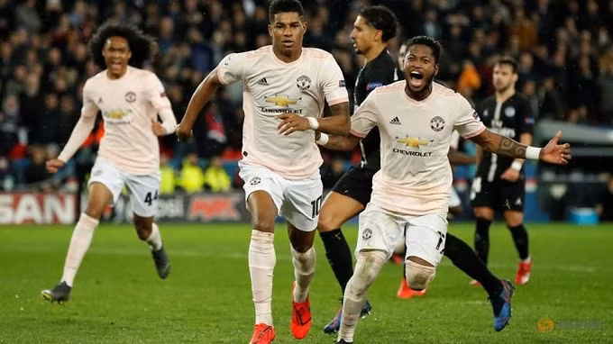 Manchester United's Marcus Rashford celebrates scoring their third goal with team mates. (Reuters)