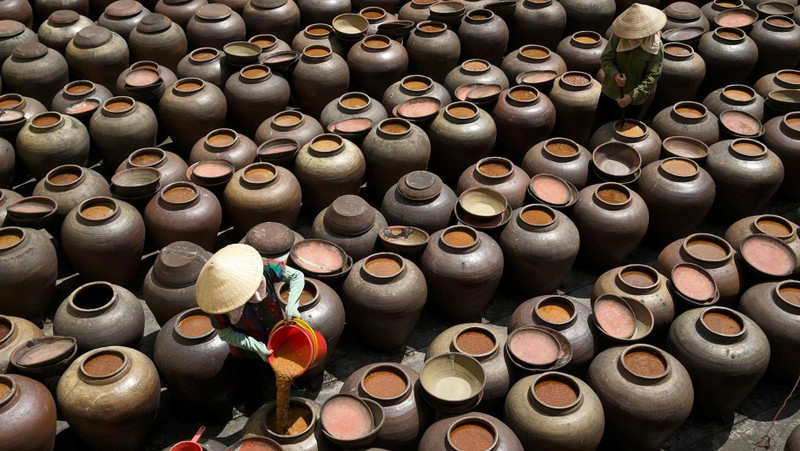 Visiting Ban village to explore the traditional craft of soya sauce making.
