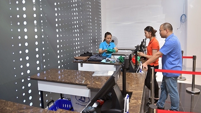 Customers buy apparel products at a fashion centre on Ba Trieu Street, Hanoi