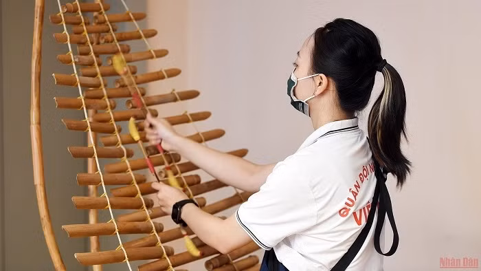 Tuning the bamboo xylophone.