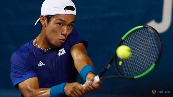 FILE PHOTO: Tennis - 2018 Asian Games - Men's Singles - Semi-Final 2 - JSC Tennis Court - Palembang, Indonesia - August 24, 2018. Lee Duck-hee of South Korea hits a shot against Wu Yibing of China. (Reuters)
