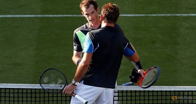 Britain's Andy Murray shakes hands with Switzerland's Stan Wawrinka after winning their first round match. (Photo: Reuters)