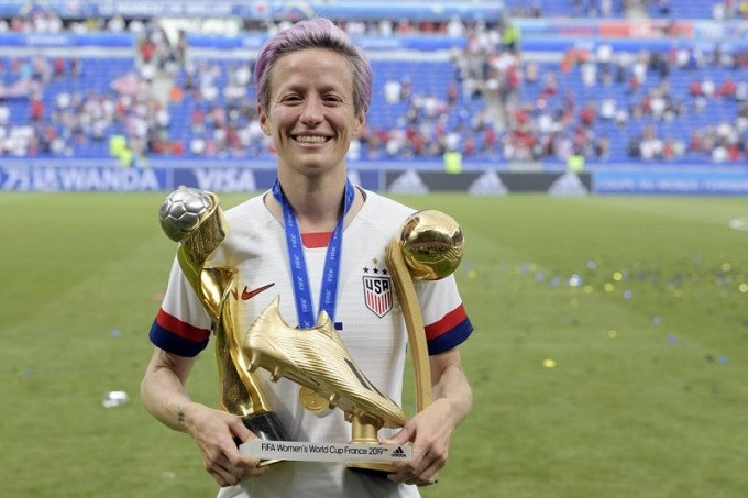Megan Rapinoe poses with the Women's World Cup trophy, the Golden Boot and the Golden Ball. (Photo: Getty)