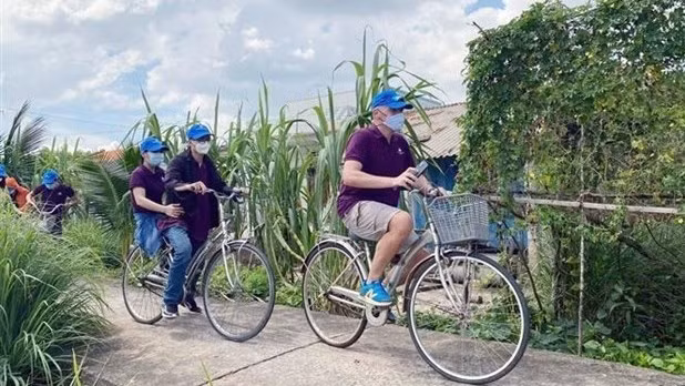 Tourists ride bicycles to tour Can Gio district of Ho Chi Minh City (Photo: VNA)