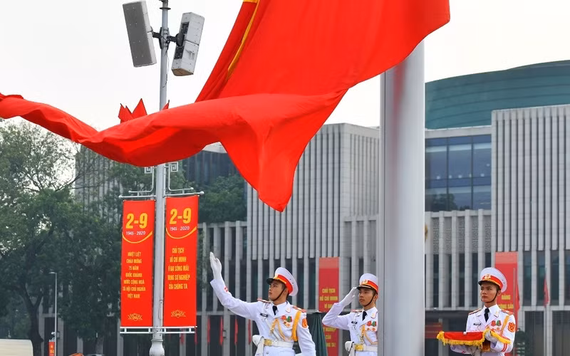 The national flag flying surrounded by the music of the national anthem at Ba Dinh Square.
