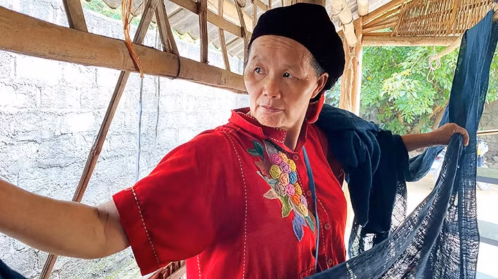 Vang Thi Mai, founder of the Brocade Weaving Cooperative of Hop Tien Commune. has worked to diversify her products for customers.