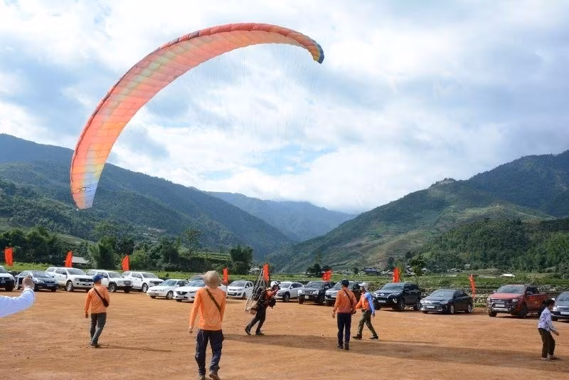 Tourists preparing to paraglide over the golden season of Mu Cang Chai.