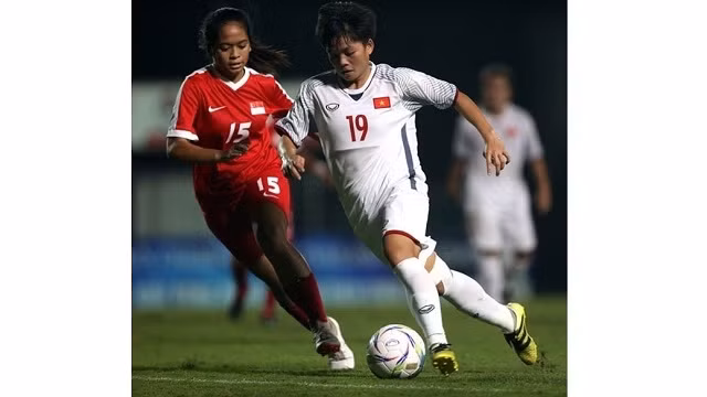 Vietnam team (in white) crushed Singapore 11-0 in the match took place yesterday.