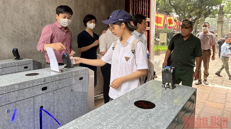 Tourists swipe their cards to visit Van Mieu - Quoc Tu Giam relic.