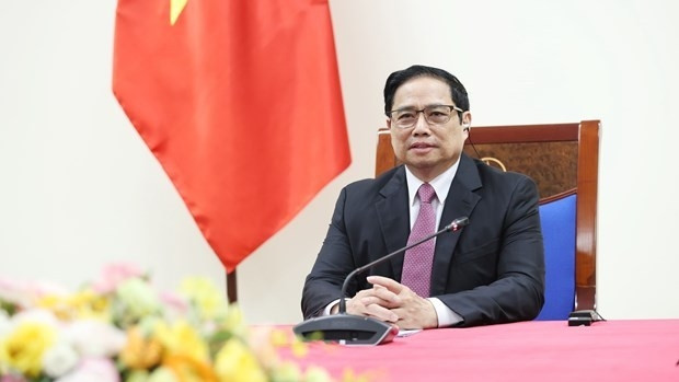 Prime Minister Pham Minh Chinh during the phone talks with Managing Director of the COVAX Facility Aurélia Nguyen. (Photo: VNA)