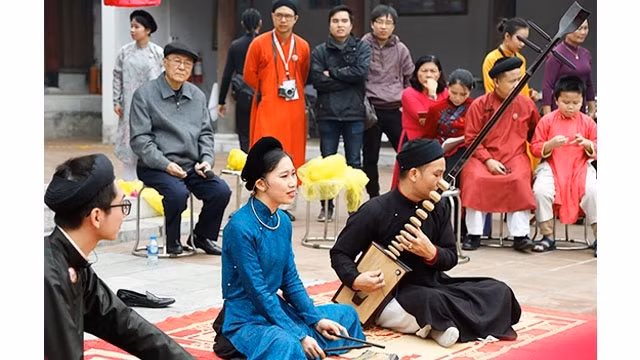 Vocalist Kim Ngoc and her teammate performing at a cultural event. (Photo: ND/Anh Quan)