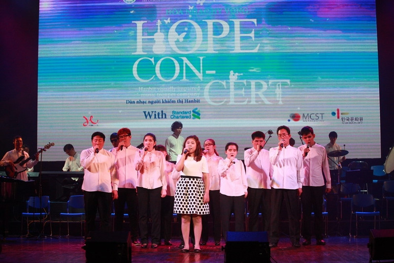 Lee Ah Rum and the troupe sing the song 'the Power of Love'