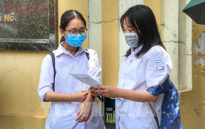 Candidates talk to each other after completing the first test on June 14. (Photo: VNA)