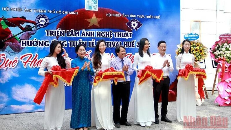Delegates cut the ribbon at the opening ceremony of the exhibition "Homeland through the lens of photography".