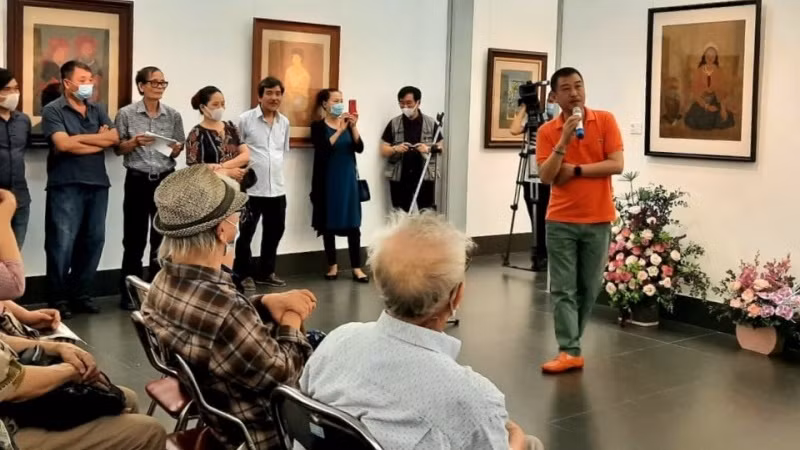 Artist Le Thiet Cuong introduces paintings by artist Linh Chi at the opening of the exhibition. (Photo: NDO/Giang Nam)
