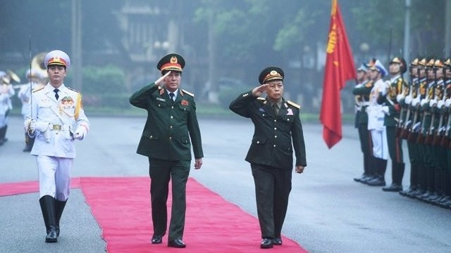 Gen. Luong Cuong, Standing Member of the Central Military Commission and Director of the Vietnam People’s Army (VPA) General Department of Politics, and Lieut. Gen. Thongloy Silivong, Deputy Defence Minister and Director of the Lao People’s Army (LPA) General Department of Politics, inspect the Guard of Honour during a welcoming ceremony in Hanoi on March 19. 