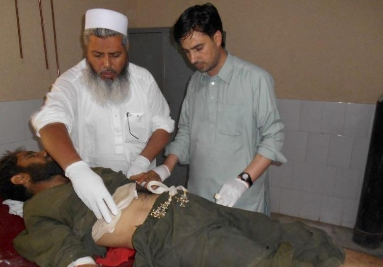 Medical personnel attend to a victim after a suicide bomb attack at a mosque, at a hospital in Bajaur Agency, outside Peshawar, Pakistan. (Credit: Reuters)
