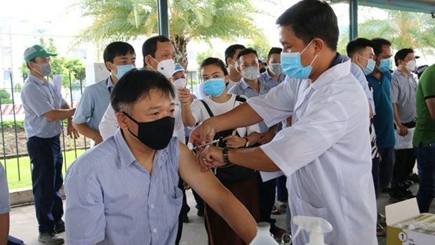 All agencies are asked to continue administering booster doses for those 18 and above, and complete second doses for those aged 5 -12 in August. (Photo: VNA)